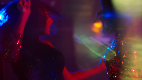 Close-Up-Of-Two-Women-In-Nightclub-Bar-Or-Disco-Dancing-With-Sparkling-Lights-15